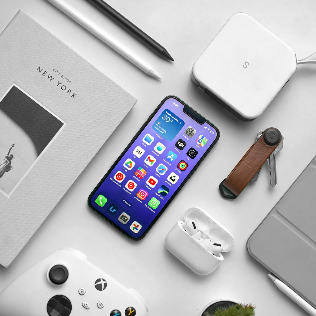 a cell phone sitting on top of a table next to a laptop